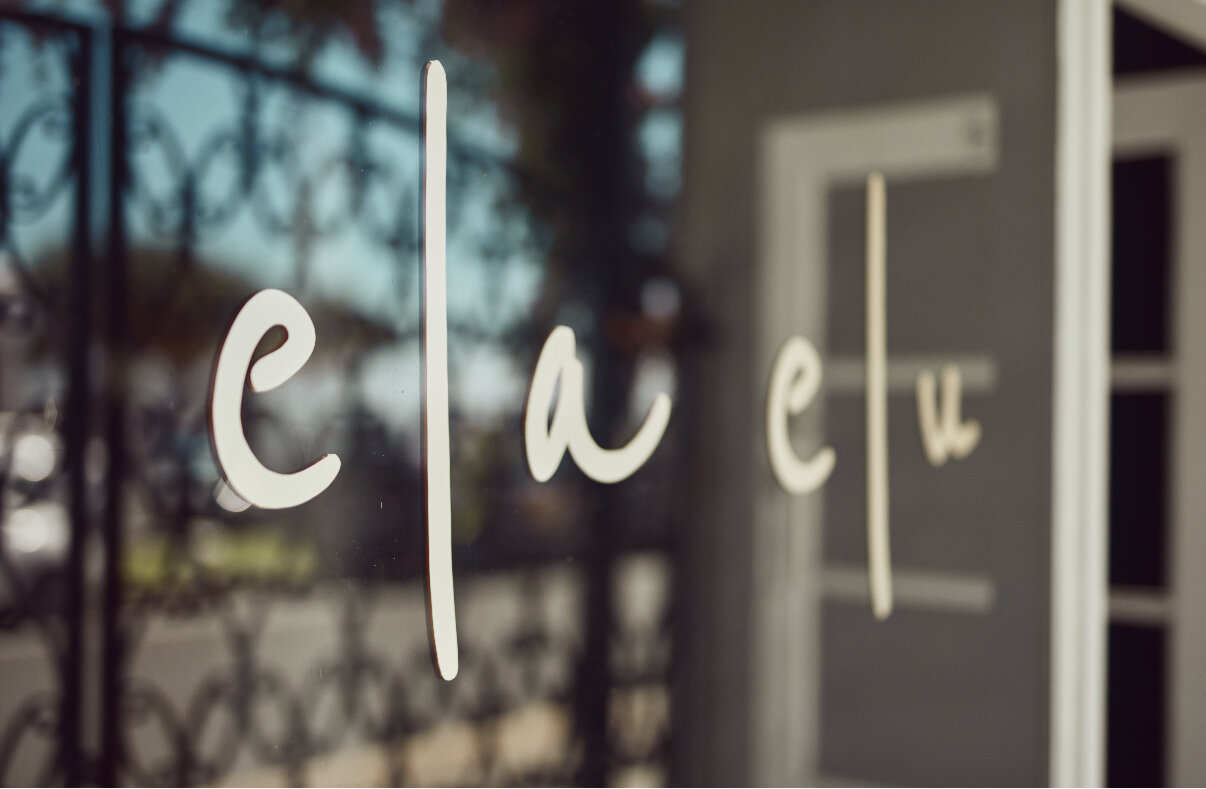 The hand-painted signage on the front door of Ela Elu at 796 Pacific Parade, Currumbin