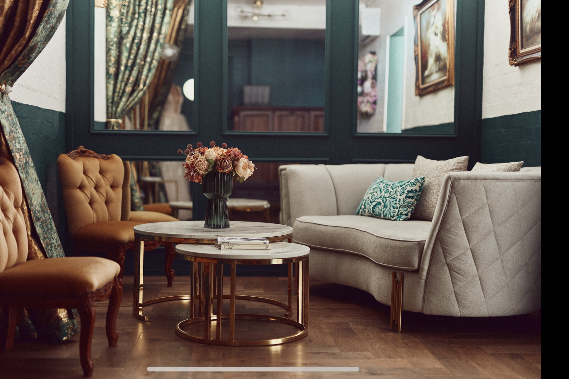 The fitting salon at Ela Elu, with green walls and tufted velvet armchairs